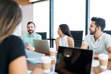 Group of business people discussing in meeting at creative office