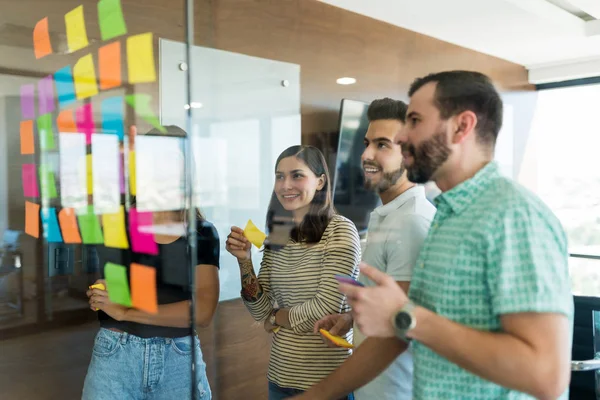 Männliche Und Weibliche Kollegen Arrangieren Klebezettel Glaswand Besprechung Büro — Stockfoto