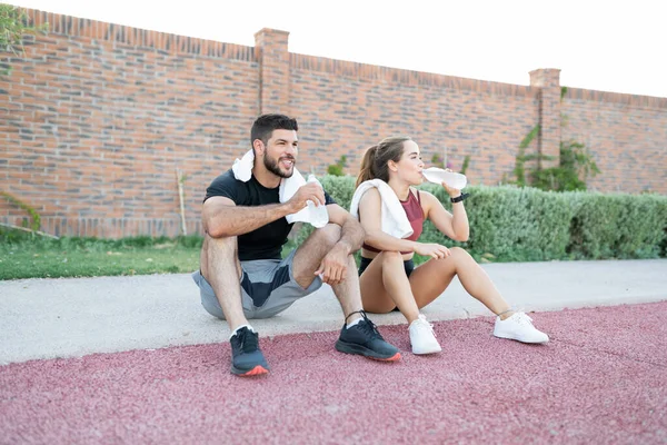 Exhausted Young Man Woman Drinking Water Jogging Park — Stock Photo, Image