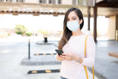 Coronavirus krizi sırasında yüz maskesi takan orta yaşlı bir kadın.