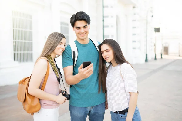 Giovane Latino Che Mostra Cellulare Agli Amici Durante Weekend Città — Foto Stock