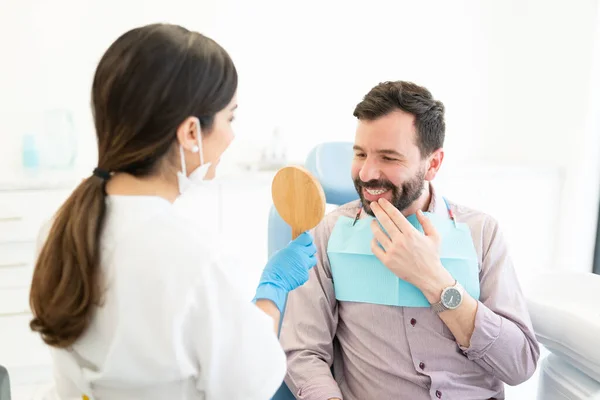 Dentista Femenina Mostrando Espejo Hombre Adulto Usando Retenedor Ortodoncia Invisible — Foto de Stock