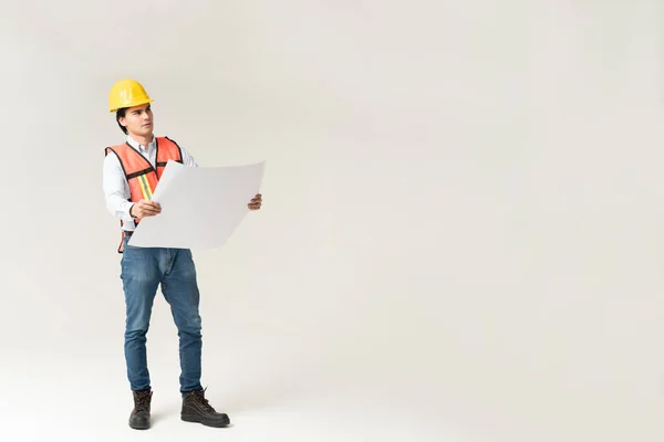 Full Length Male Contractor Looking Away While Holding Building Plan — Stock Photo, Image