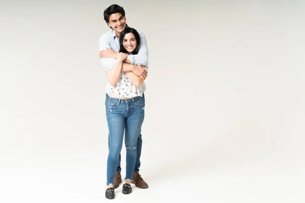 Smiling Boyfriend Hugging Good Looking Girlfriend While Standing White Background — Stock Photo, Image