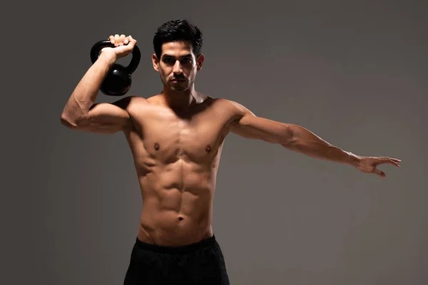 Determined Hispanic Young Male Athlete Exercising Kettlebell — Stock Photo, Image