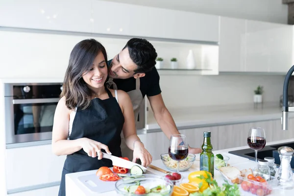 Jovem Beijando Feliz Namorada Cortando Legumes Cozinha — Fotografia de Stock