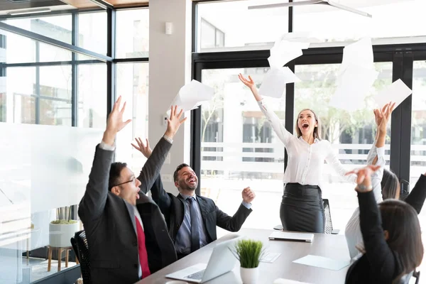 Glada Affärsmän Sitter Styrelserummet Och Kasta Papper Luften Över Konferensbordet — Stockfoto