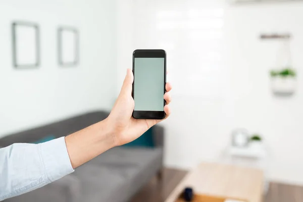 Closeup Hand Man Holding Smartphone Front Living Room Controlling Smart — Stock Photo, Image