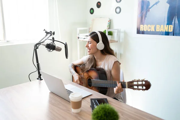 魅力的な女性と歌手がギターを演奏し ライブポッドキャストでオンライン視聴者のためのスタジオで実行 — ストック写真