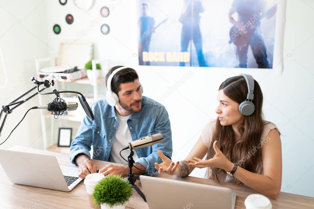 Hispanic radio hosts and bloggers talking and having an argument during a live talk show