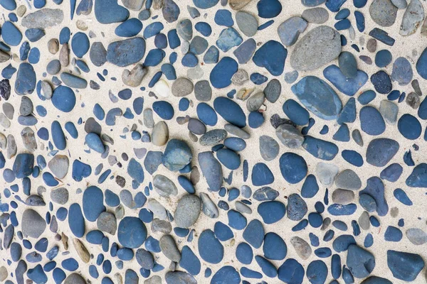 Tile consisting of blue stones of different sizes, background, texture.