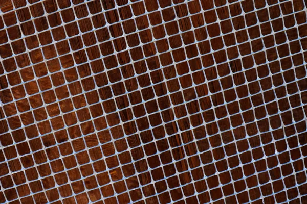 Old metal grid covered with rust and blured brown background
