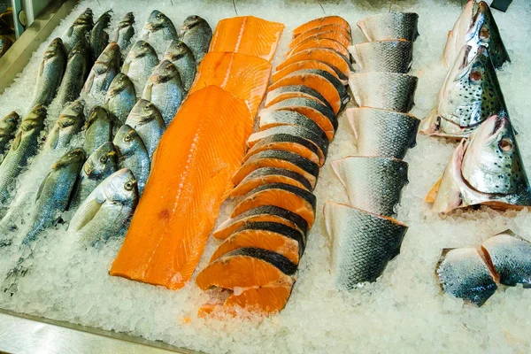 Fresh live fish on ice in an open market or supermarket.