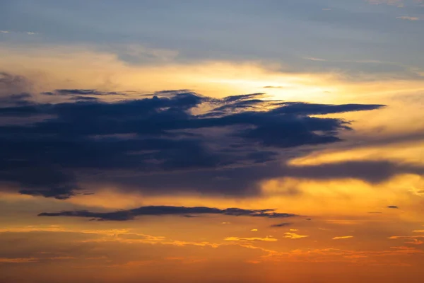 Sunset with sun rays, sky with clouds and sun.