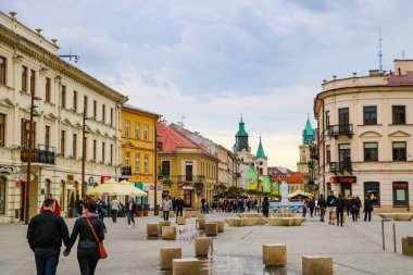 Lublin, Poland, May 9, 2019: Tourists and locals walk around the old part of Lublin. clipart