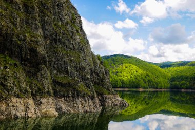 Güzel dağ manzarası ve yeşil tepeler. Göldeki tepelerin yansıması.