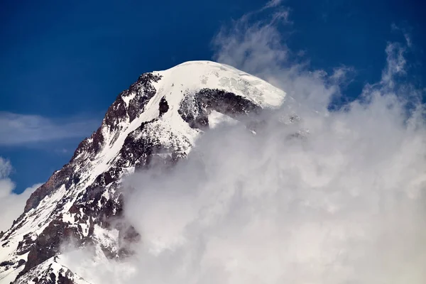 Kazbek mountain peak in the clouds.