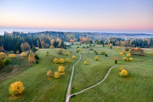 Colorful park scene in the fall with orange and yellow foliage. Beautiful autumn scenery in Lithuania.