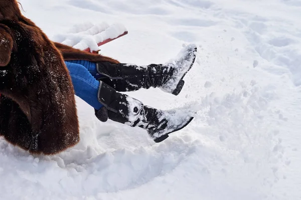 Women\'s winter boots in the snow.