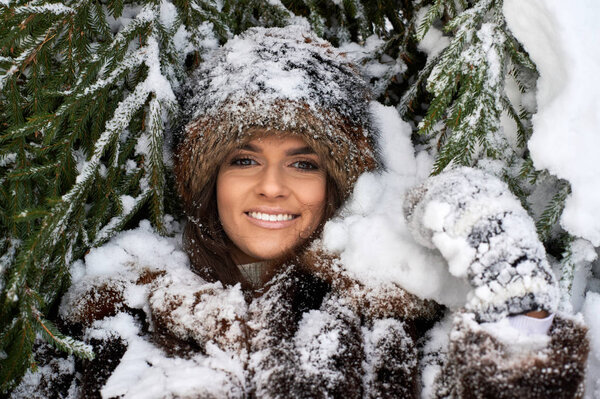 Young girl enjoying snow outdoors in winter.