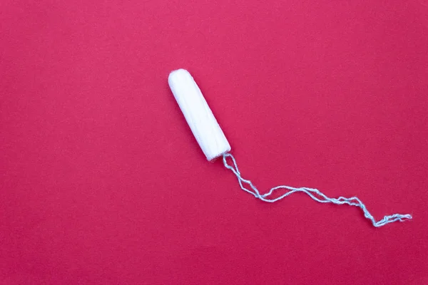 Tampon for menstruation. The concept of critical days. Its red — Stock Photo, Image