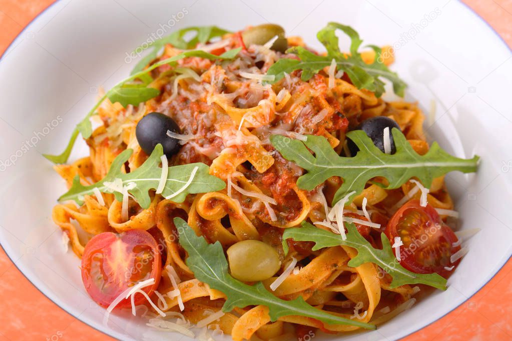 Pasta Bolognese with tomato sauce, olive and cheese