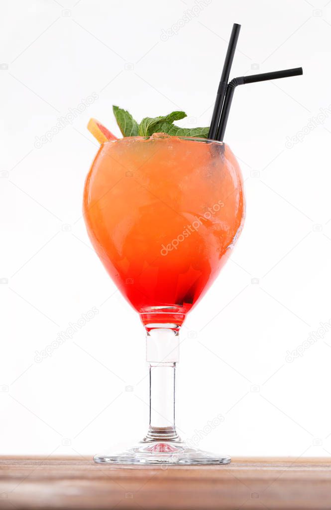 Cold alcohol cocktail with grenadine and ice cubes