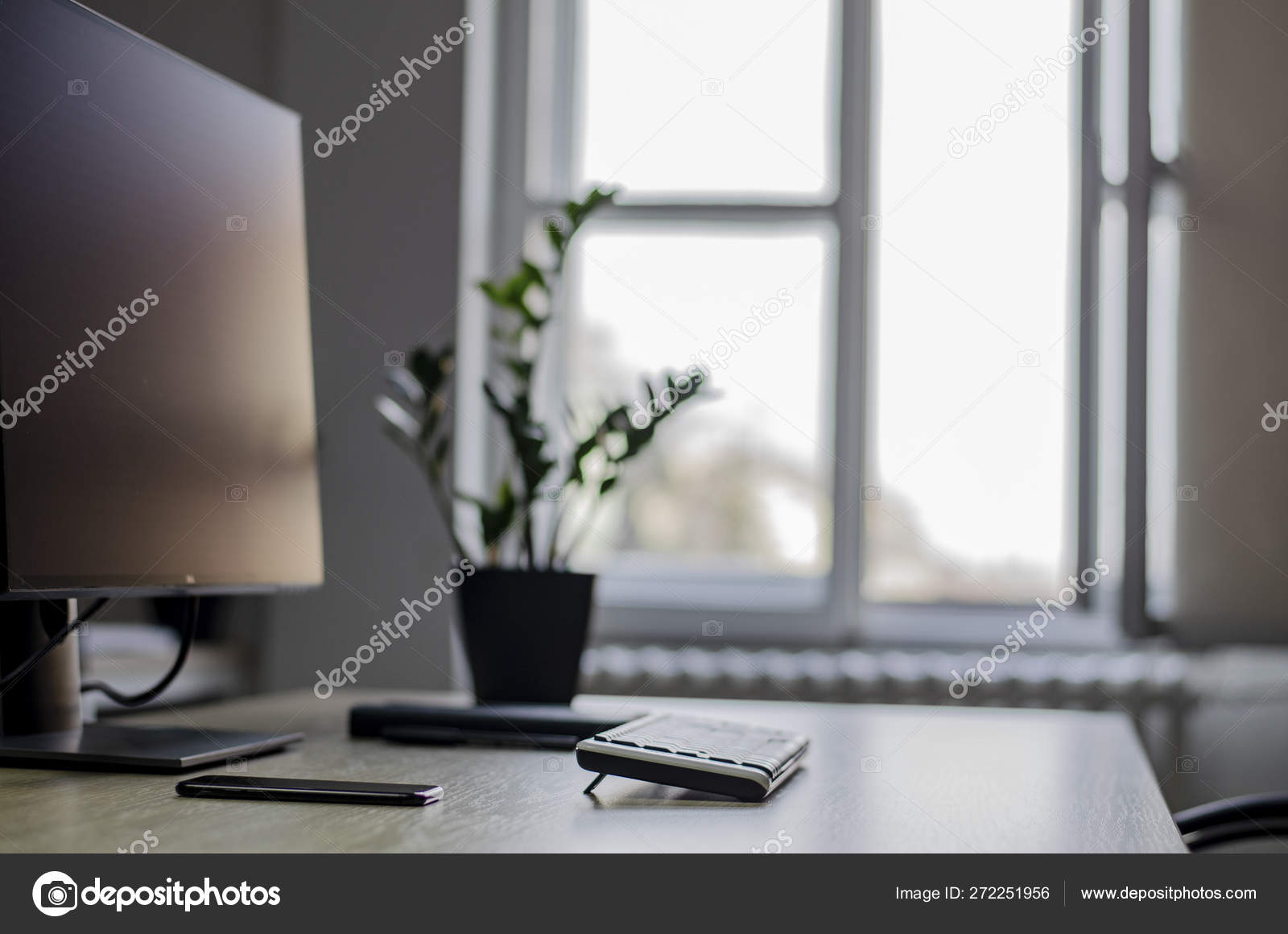 Neat Office Desk By The Window Side View Stock Photo