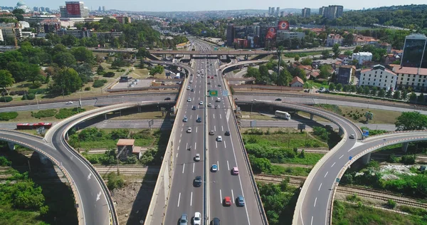 Traffic intersection. Road, cars, trucks. Camera high above the road. Drone shot.