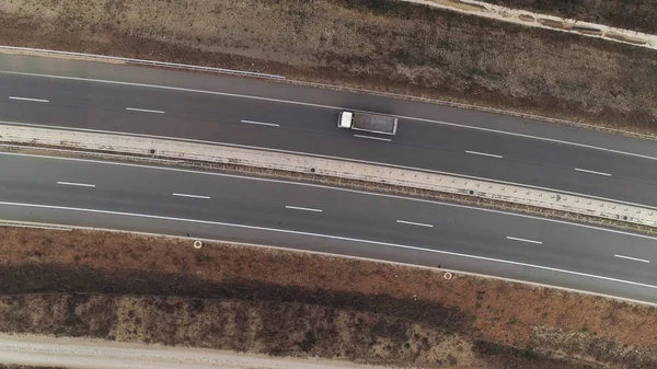 Road top down drone shot aerial truck passing