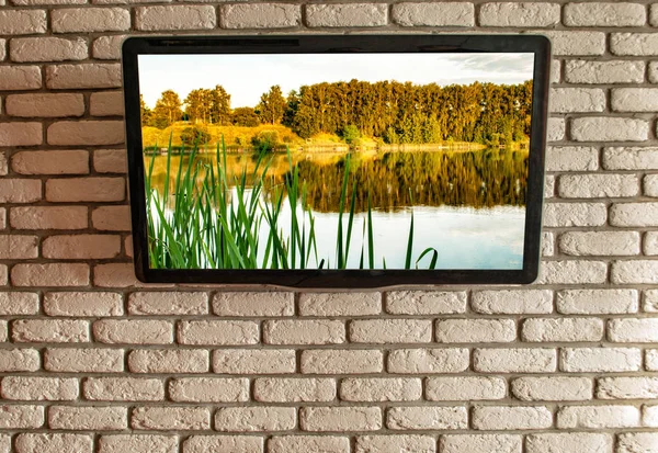 TV on the wall of decorative brick