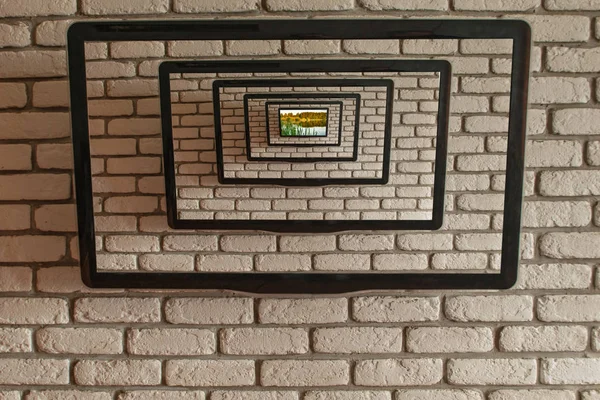 TV on the wall of gray decorative brick