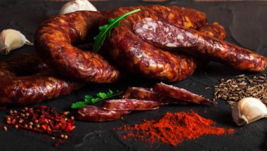 Thin uncooked smoked pork and beef sausages. Delicatessen meat. clipart