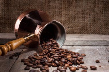 kahve çekirdekleri ve bakır kahve Türk ahşap arka plan üzerinde dağınık