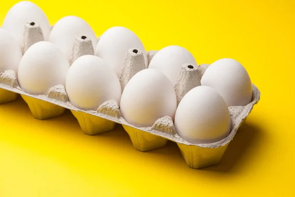 Biały Surowe Jaja Pakiet Żółtym Tle Bliska — Zdjęcie stockowe
