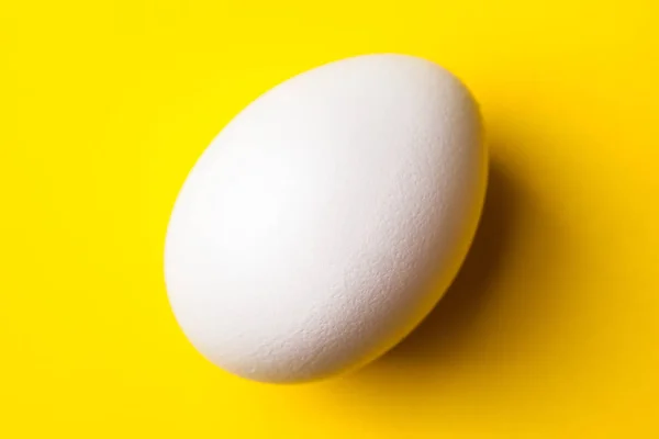Biały Surowe Jajko Żółtym Tle Bliska — Zdjęcie stockowe