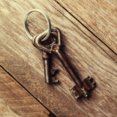kahverengi ahşap zemin üzerinde iki eski paslı anahtar