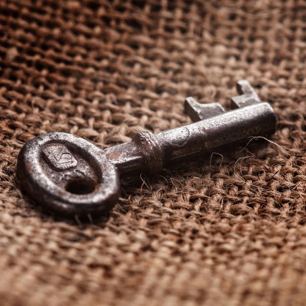 Alter Schlüssel Auf Rustikalem Sacktuch Hintergrund Nahaufnahme — Stockfoto