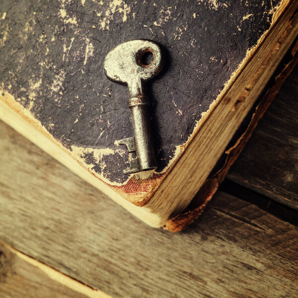 old rusty key on antique book 