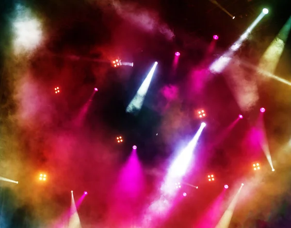 bright stage spotlights at music concert, bokeh lights background