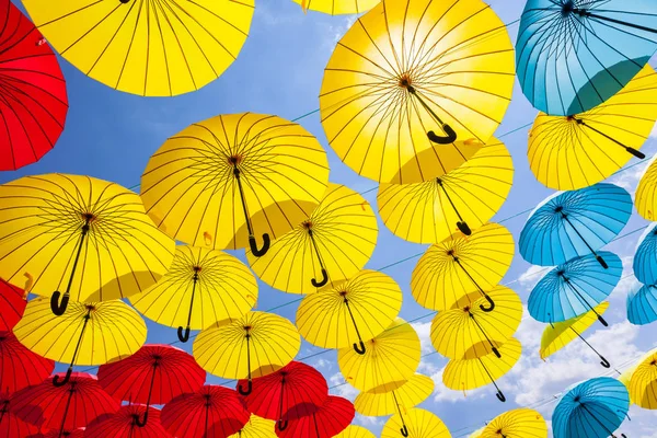 background of red umbrellas against sky, street decoration