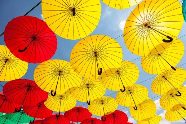 background of red umbrellas against sky, street decoration