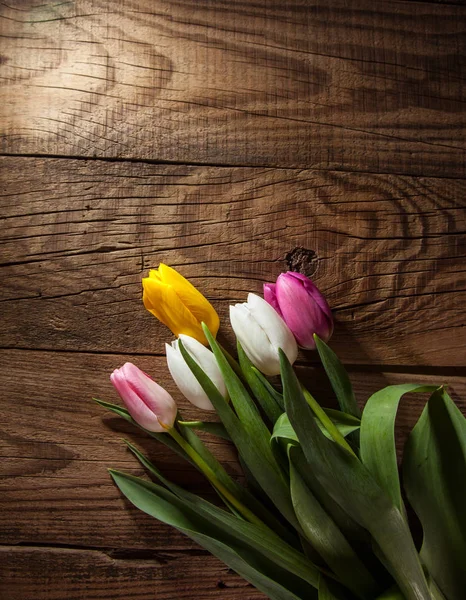 木製の背景にピンク 黄色と白のチューリップの花束 — ストック写真