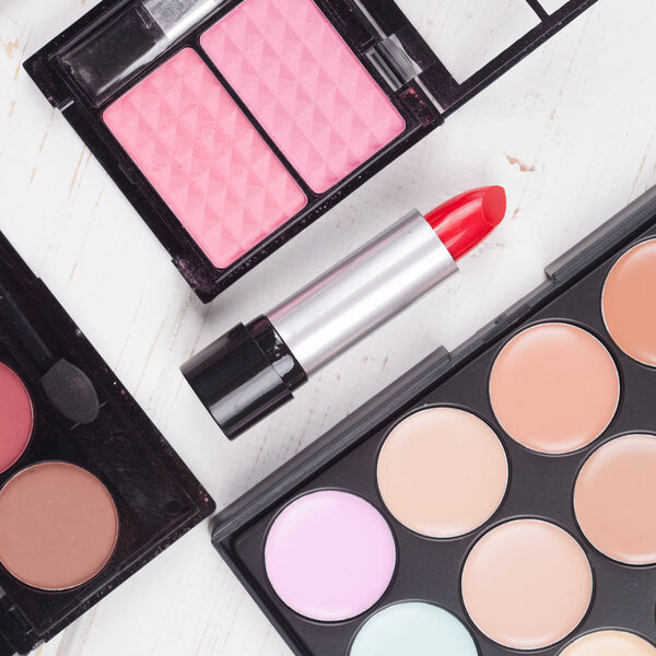 decorative cosmetics set on white wooden background