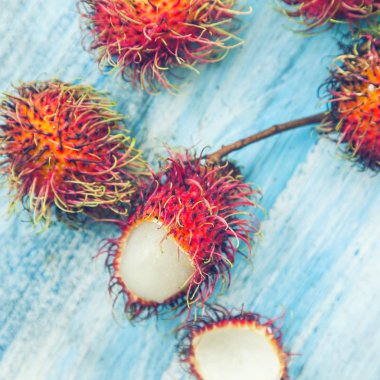 exotic Rambutan Thai fruits on blue background clipart