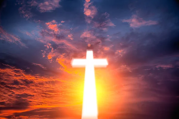 Glowing cross on beautiful sky background