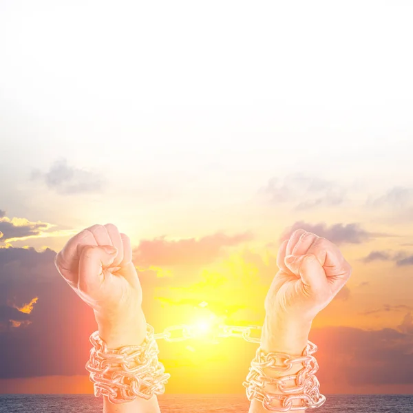 Two hands in chains on a white background