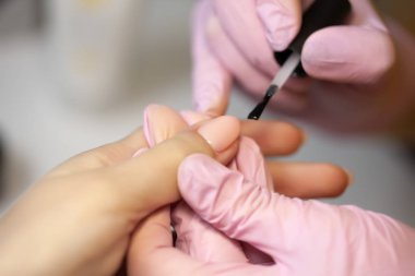 Manikür Ustası güzellik salonunda tırnak uzantıları jel yapar