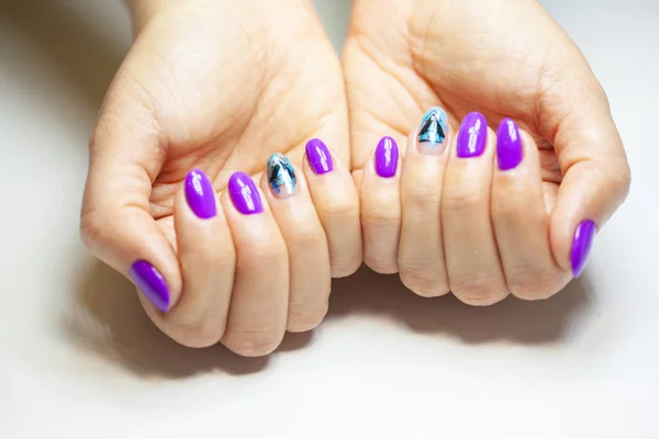 Female hands in manicure salon with a beautiful manicure