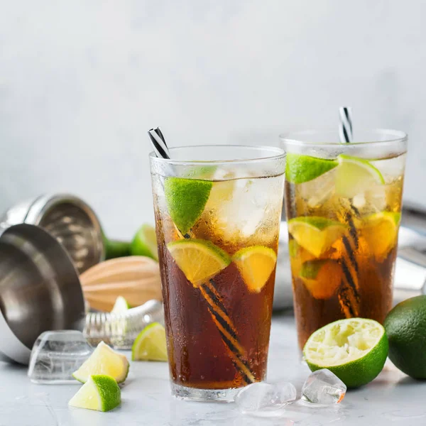 Gıda ve içecek, tatil partisi konsepti. Cuba libre veya long Island buzlu çay alkol kokteyl içki içecek, saman, buz ve limon bir tablo ile bir bardak DRINK
